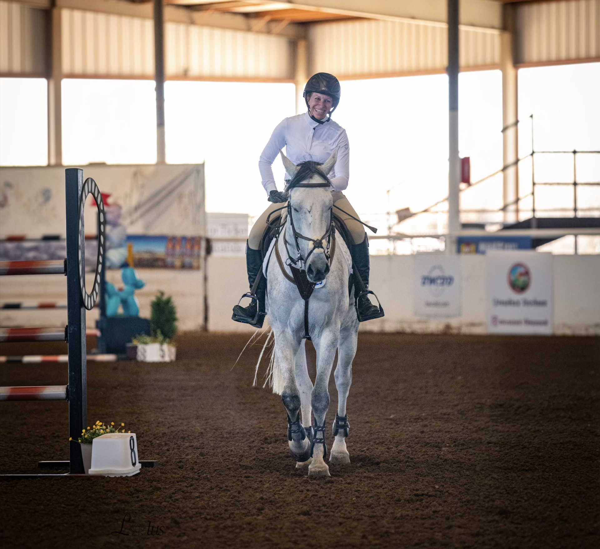 Smiling rider on a grey horse at a Pinnacle Equestrian Tour show in Arizona.